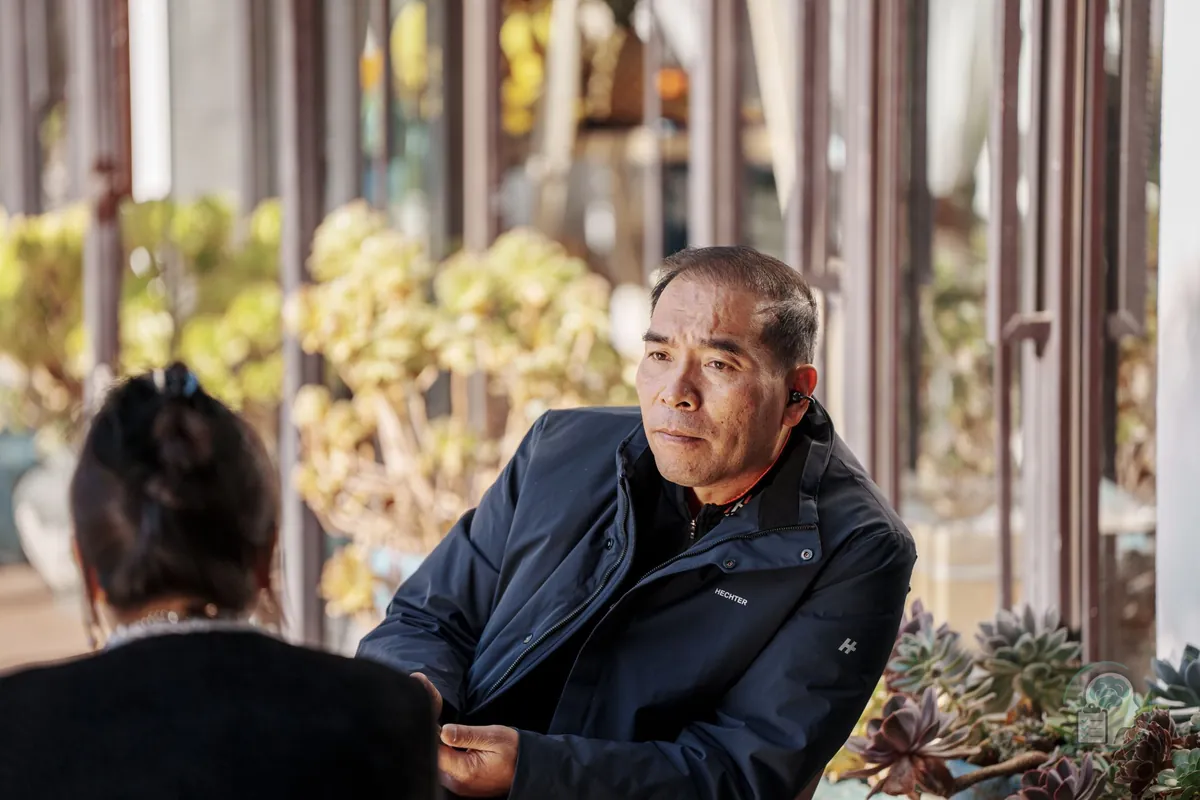 Two people talking on a terrace, the kind of support that helps in getting through a breakup