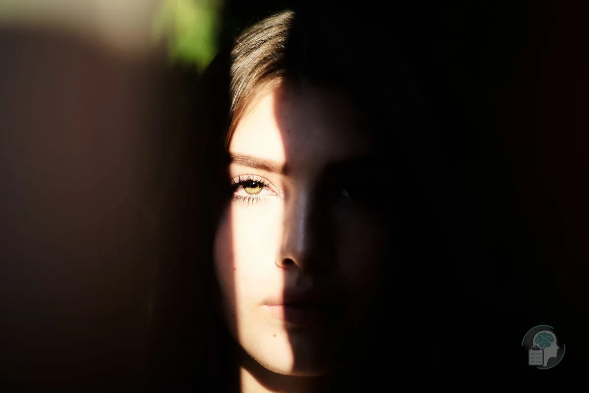 Woman's face half lit by the sun and half in shadow, an image of the mood ups and downs of cyclothymia
