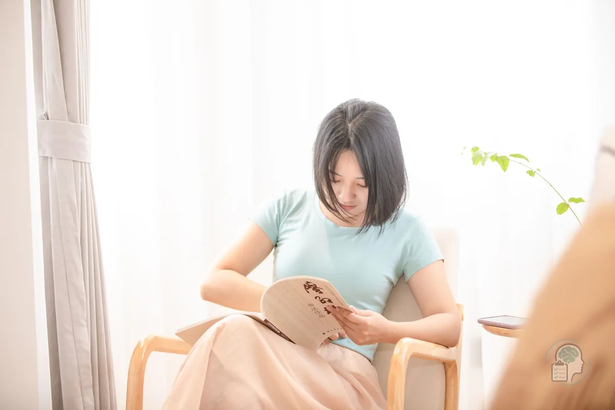 Woman reading by a window in a bright, quiet room, the recovery time after a day of overstimulation